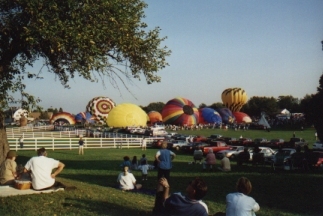 Picture of crowd watching balloons inflate.
